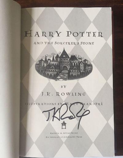 JK Rowling Forgery inside of a Harry Potter and the Sorcerer's Stone sold by AwesomeMemorabilia.com